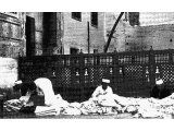 Arab tent makers plying their craft in a yard in Jerash. An early photograph.